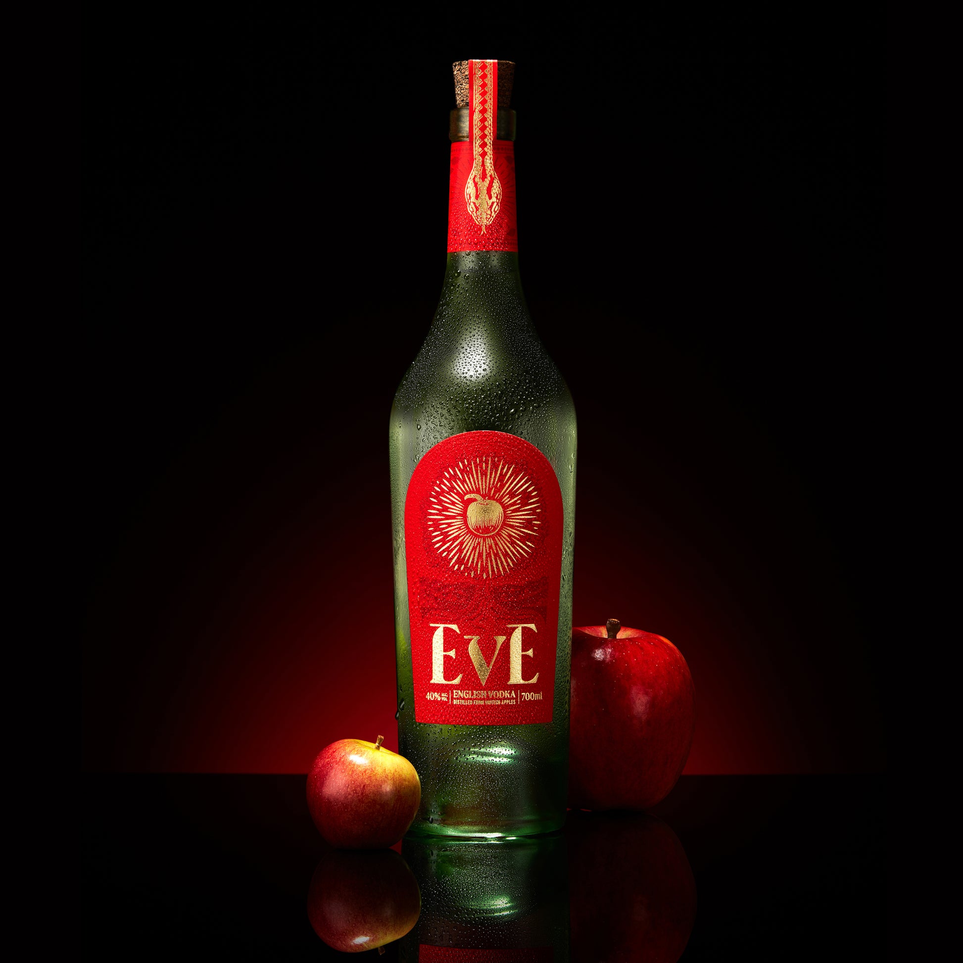 Bottle of Eve Vodka by Pleasant Land Distillery with elegant label and braeburn apples
